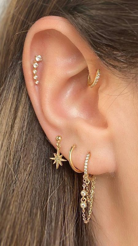  A woman with gold earrings and a star.